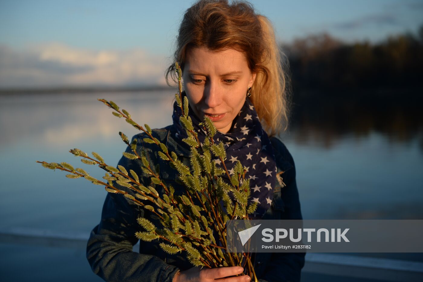 People collect willow branches for Palm Sunday on Lake Shartash in Yekaterinburg