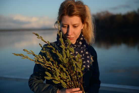 People collect willow branches for Palm Sunday on Lake Shartash in Yekaterinburg