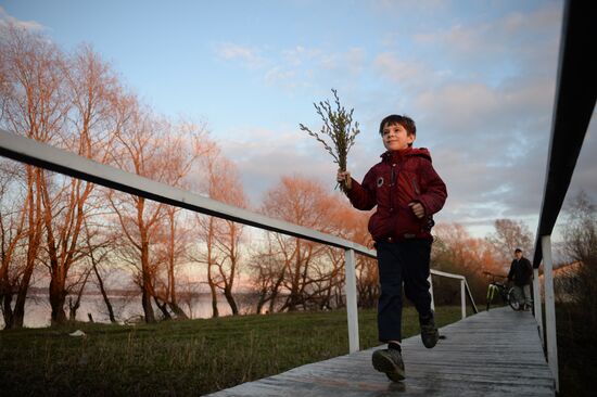 People collect willow branches for Palm Sunday on Lake Shartash in Yekaterinburg