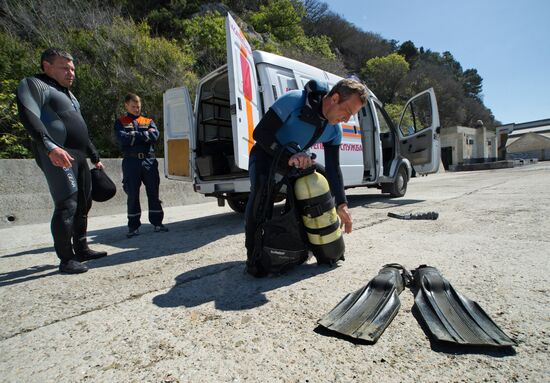 Diver examinsation and bottom cleansing off Crimean beach shore