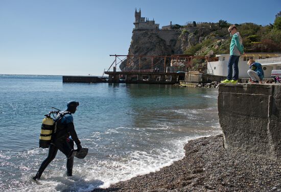 Diver examinsation and bottom cleansing off Crimean beach shore