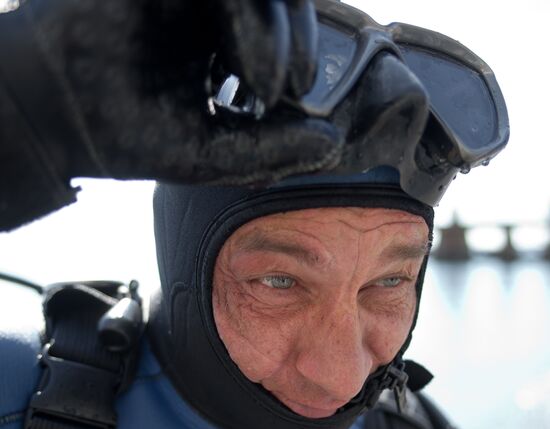 Diver examinsation and bottom cleansing off Crimean beach shore