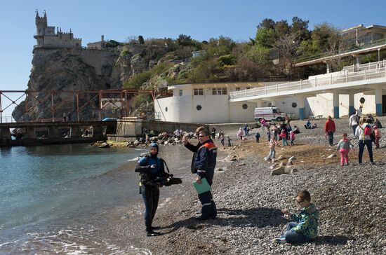 Diver examinsation and bottom cleansing off Crimean beach shore