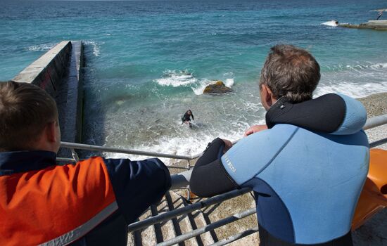 Diver examinsation and bottom cleansing off Crimean beach shore