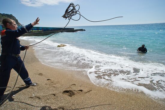 Diver examinsation and bottom cleansing off Crimean beach shore