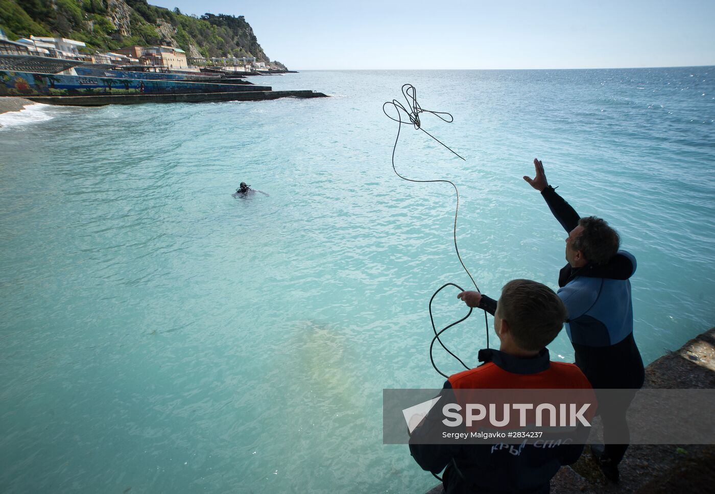 Diver examinsation and bottom cleansing off Crimean beach shore