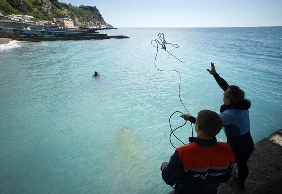Diver examinsation and bottom cleansing off Crimean beach shore