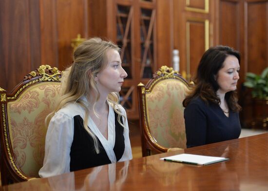 President Vladimir Putin meets with widows of journalists killed in Ukraine performing professional duty
