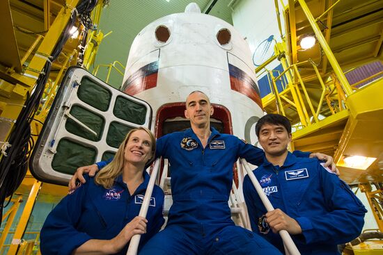 ISS Expedition 48/49 crew examines vessel