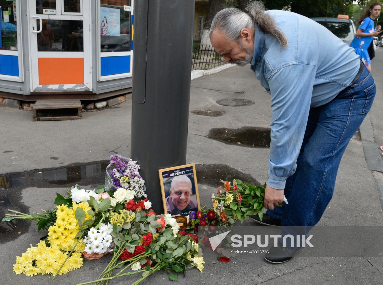 Flowers and candles on the site of murder of journalist Pavel Sheremet in Kiev
