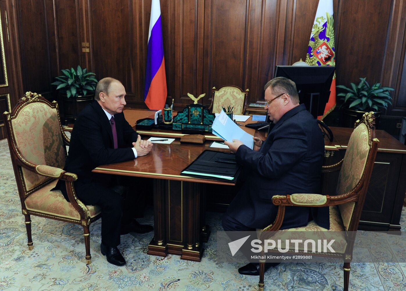 Russian President Vladimir Putin meets with Vladimir Ustinov