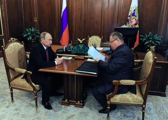 Russian President Vladimir Putin meets with Vladimir Ustinov