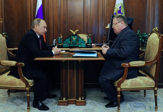Russian President Vladimir Putin meets with Vladimir Ustinov