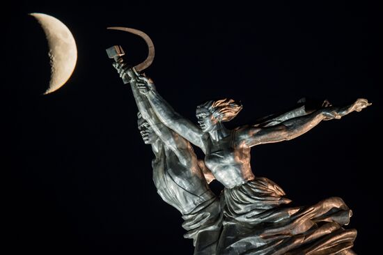Worker and Collective Farm Woman monument and waxing moon in Moscow