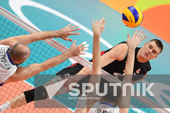 From left: Russia's Sergei Tetyukhin, Canada's John Perrin and Russia's Alexander Volkov during the quarterfinals of the men's volleyball between Canada and Russia at the XXXI Summer Olympics. Location: Brazil, Rio de Janeiro. Author: Ramil Sitdikov/Sputnik. The 2016 Summer Olympics. Volleyball. Men. Canada vs. Russia