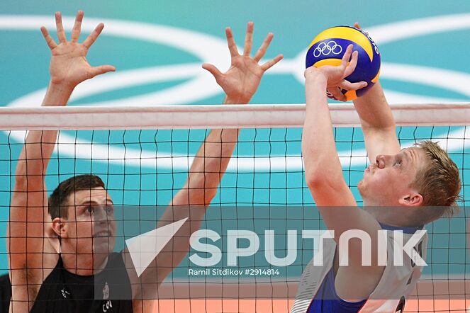 Canada's Graham Vigrass, left, and Russia's Sergei Grankin during the quarterfinals of the men's volleyball between Canada and Russia at the XXXI Summer Olympics. Location: Brazil, Rio de Janeiro. Author: Ramil Sitdikov/Sputnik. The 2016 Summer Olympics. Volleyball. Men. Canada vs. Russia