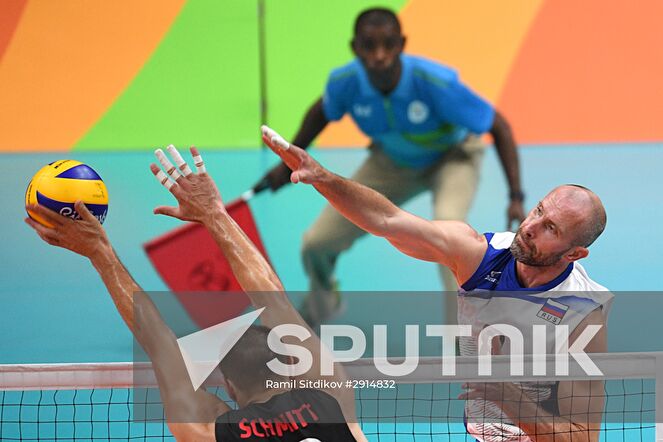 Canada's Gavin Schmitt, left, and Russia's Sergei Tetyukhin during the quarterfinals of the men's volleyball between Canada and Russia at the XXXI Summer Olympics. Location: Brazil, Rio de Janeiro. Author: Ramil Sitdikov/Sputnik. The 2016 Summer Olympics. Volleyball. Men. Canada vs. Russia