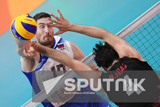 Russia's Maxim Mikhailov, left, and Canada's Nicholas Hoag during the quarterfinals of the men's volleyball between Canada and Russia at the XXXI Summer Olympics. Location: Brazil, Rio de Janeiro. Author: Ramil Sitdikov/Sputnik. The 2016 Summer Olympics. Volleyball. Men. Canada vs. Russia