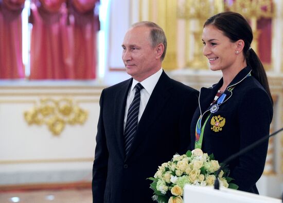 President Vladimir Putin gives government awards to Olympic medalists