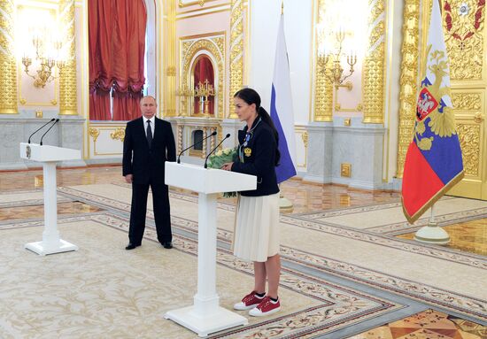 President Vladimir Putin gives government awards to Olympic medalists