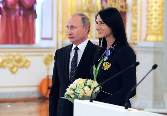 President Vladimir Putin gives government awards to Olympic medalists