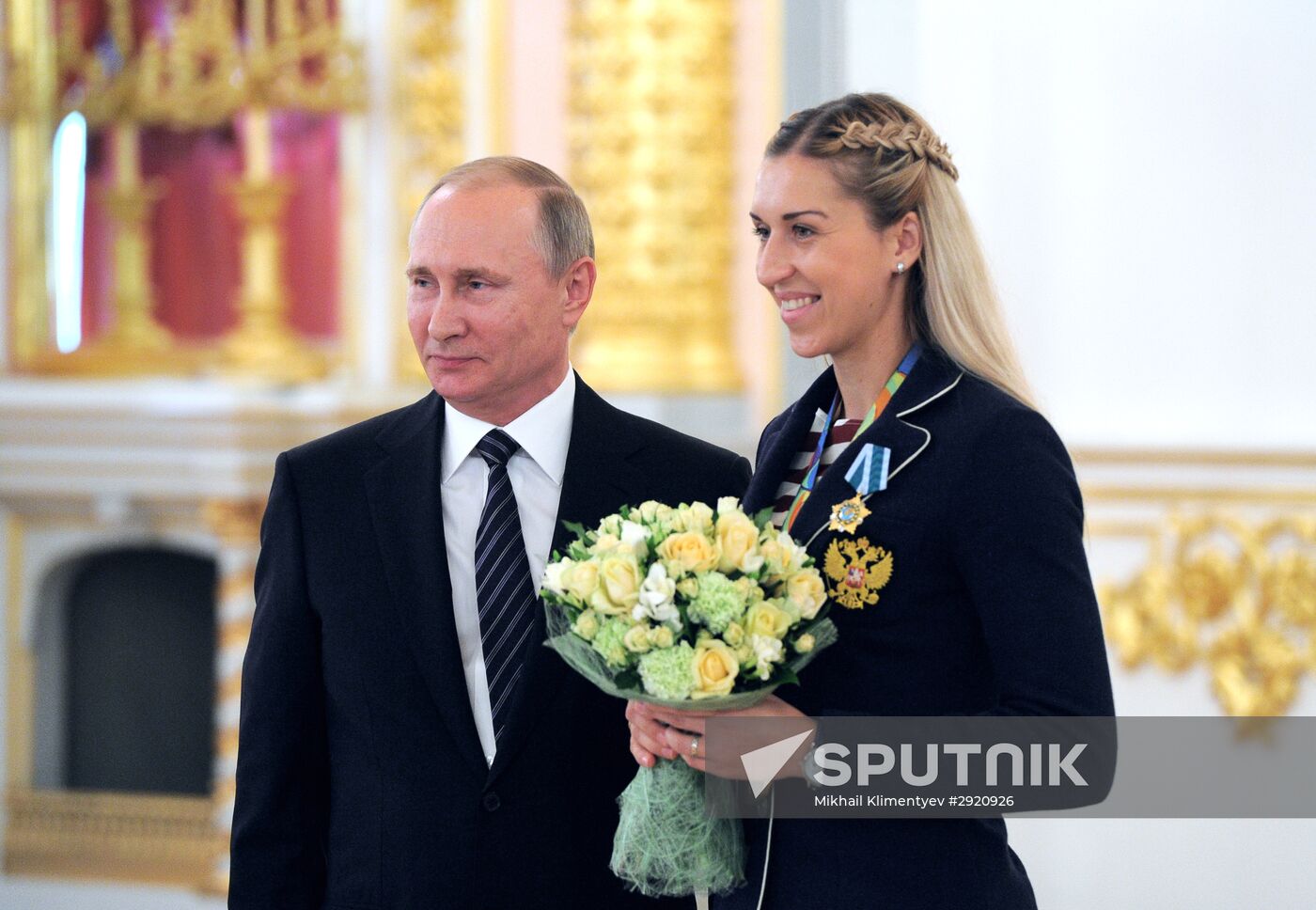 President Vladimir Putin gives government awards to Olympic medalists