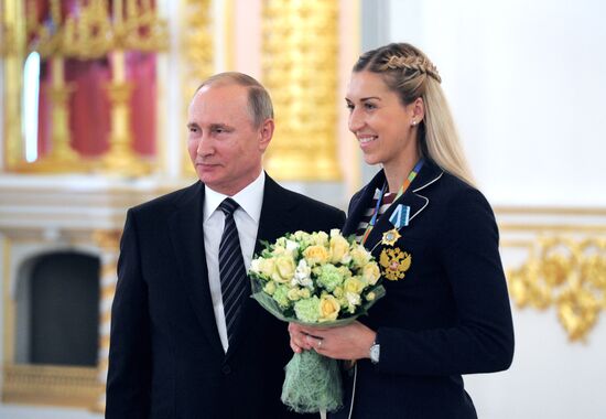 President Vladimir Putin gives government awards to Olympic medalists
