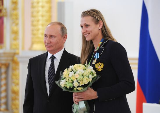 President Vladimir Putin gives government awards to Olympic medalists