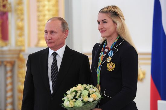 President Vladimir Putin gives government awards to Olympic medalists