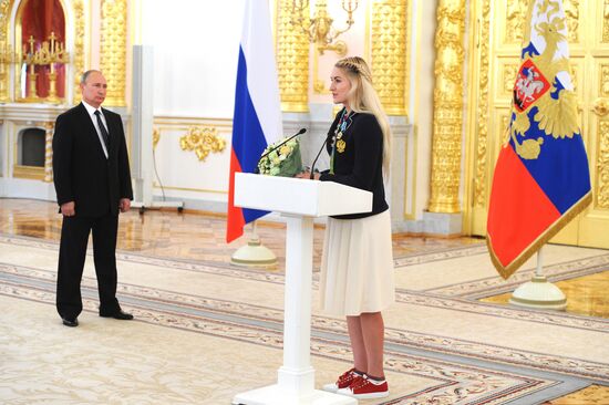 President Vladimir Putin gives government awards to Olympic medalists