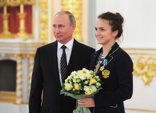President Vladimir Putin gives government awards to Olympic medalists