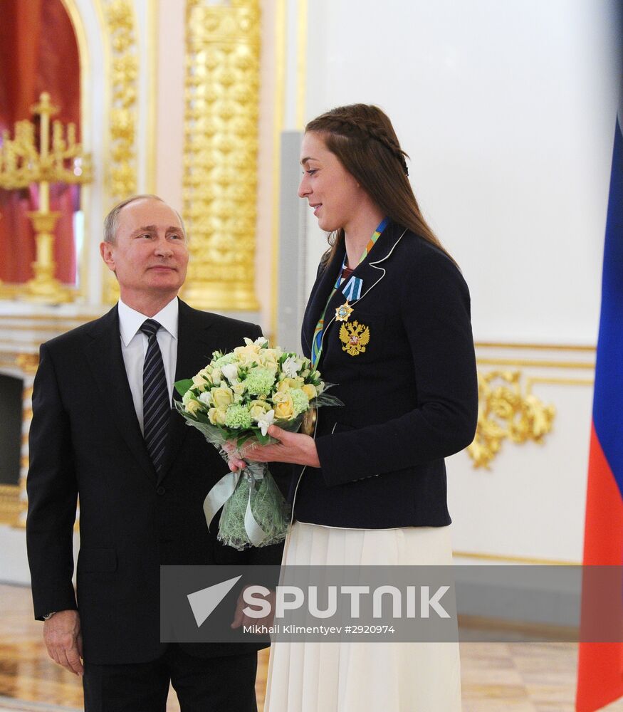 President Vladimir Putin gives government awards to Olympic medalists