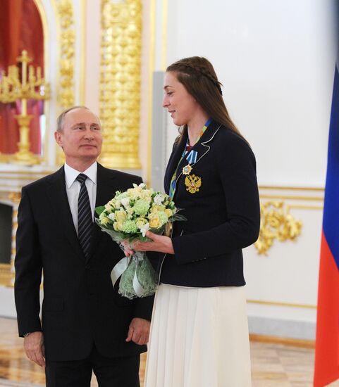 President Vladimir Putin gives government awards to Olympic medalists