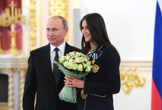 President Vladimir Putin gives government awards to Olympic medalists