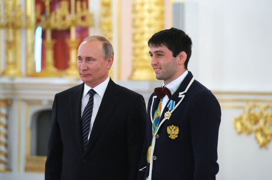 President Vladimir Putin gives government awards to Olympic medalists