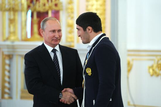President Vladimir Putin gives government awards to Olympic medalists