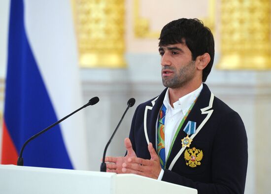 President Vladimir Putin gives government awards to Olympic medalists