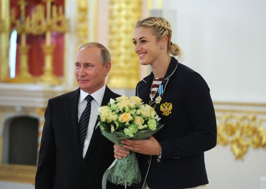 President Vladimir Putin gives government awards to Olympic medalists