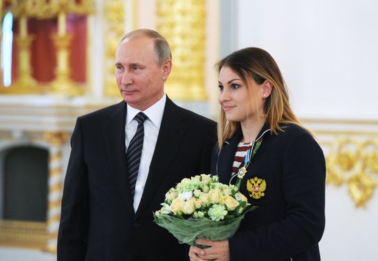 President Vladimir Putin gives government awards to Olympic medalists