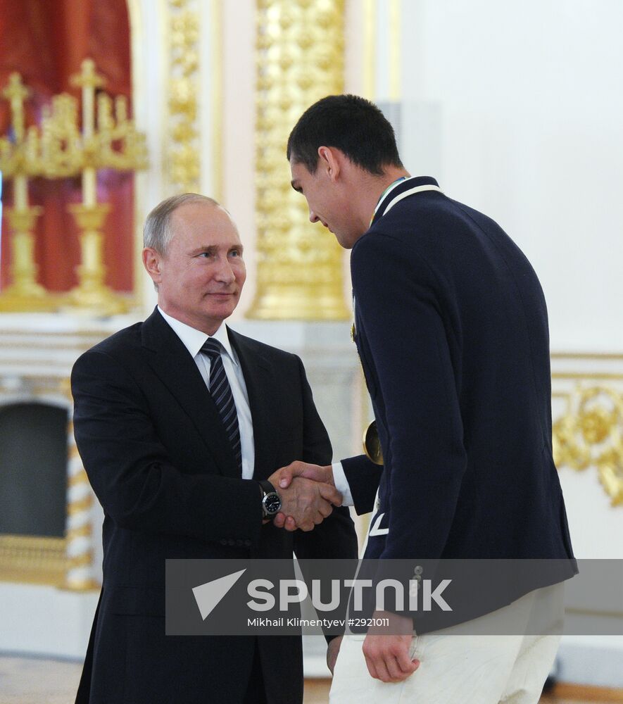 President Vladimir Putin gives government awards to Olympic medalists