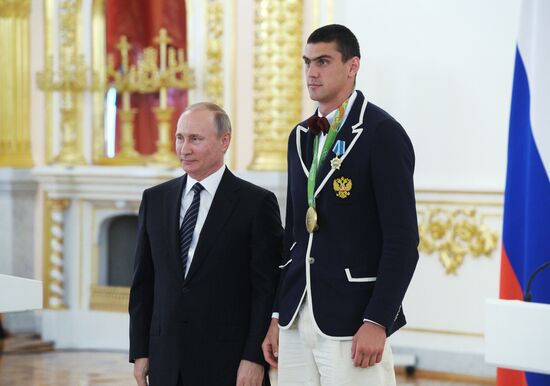 President Vladimir Putin gives government awards to Olympic medalists