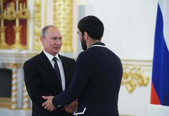 President Vladimir Putin gives government awards to Olympic medalists
