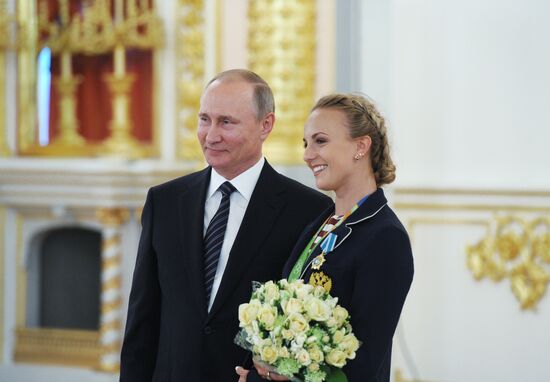 President Vladimir Putin gives government awards to Olympic medalists