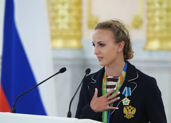 President Vladimir Putin gives government awards to Olympic medalists