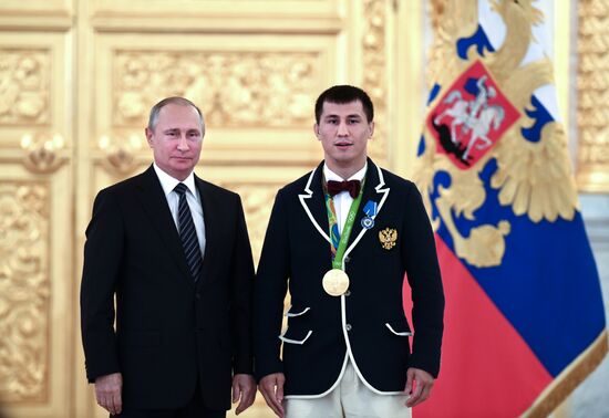 President Vladimir Putin gives government awards to Olympic medalists