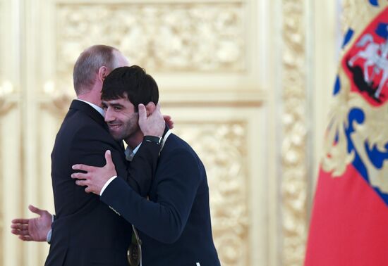 President Vladimir Putin gives government awards to Olympic medalists