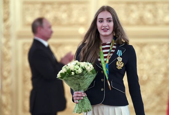 President Vladimir Putin gives government awards to Olympic medalists