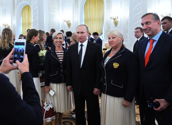 President Vladimir Putin gives government awards to Olympic medalists
