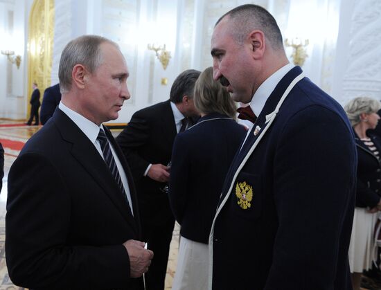 President Vladimir Putin gives government awards to Olympic medalists