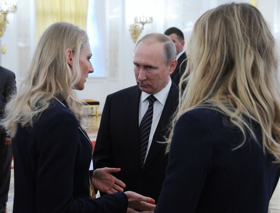 President Vladimir Putin gives government awards to Olympic medalists